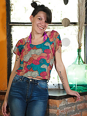 Alt milf with shaggy pussy poses nude with cheeky smile